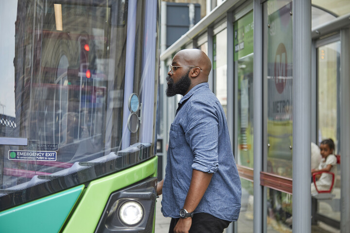 Man Getting On Bus At Stop